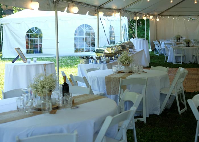 wedding tables set up under a wedding tent