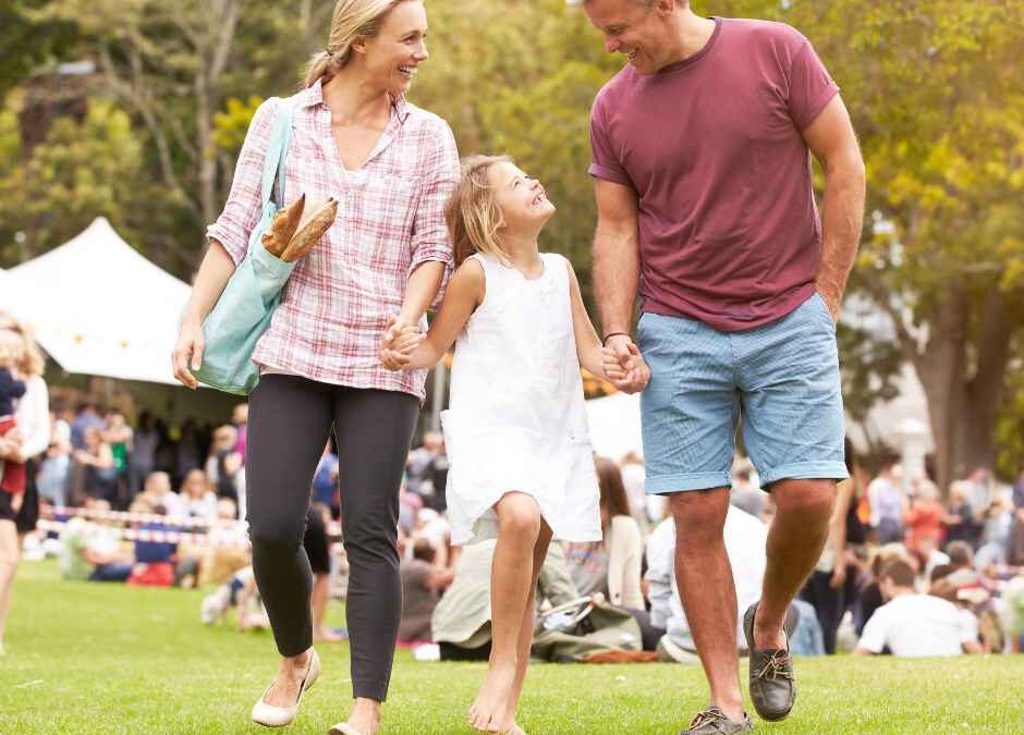 A father, mother, and daughter at an outdoor event