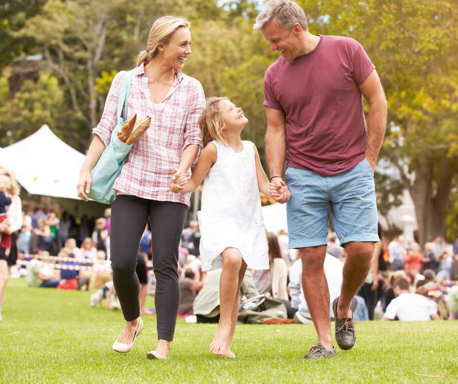 A father, mother, and daughter at an outdoor event