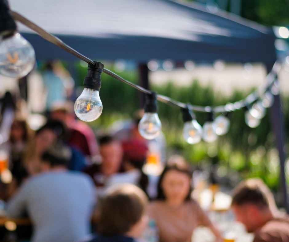 Lights hanging over a backyard party