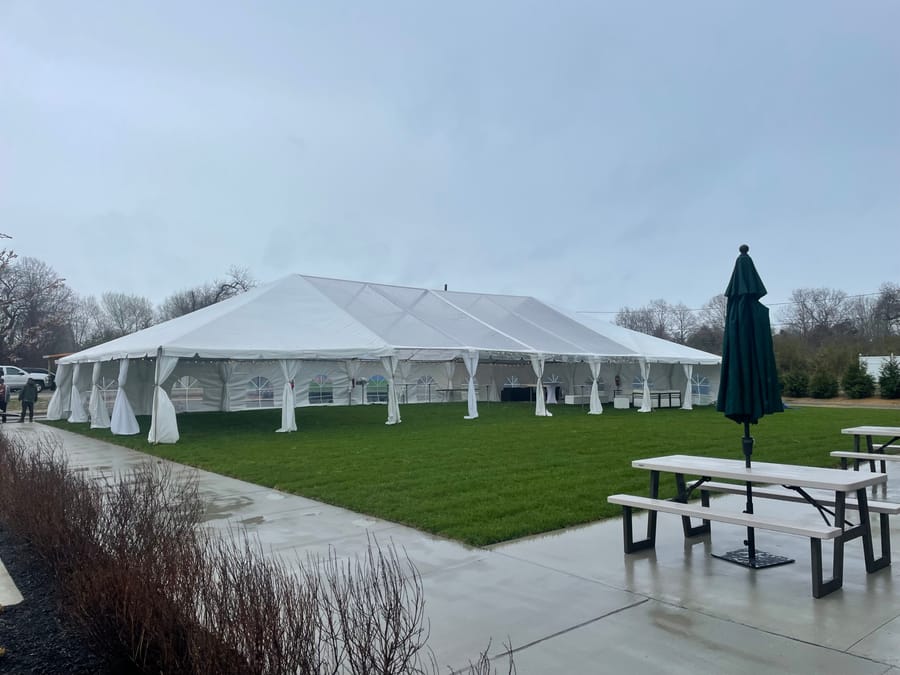 white and clear top tent set up for an event